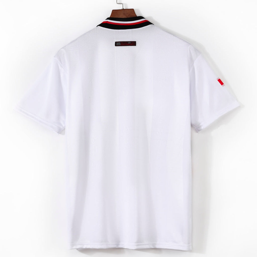 Maillot extérieur rétro Manchester United 1998-1999, marque Le 12ème Maillot, vue de face avec logo et détails de l'équipe.