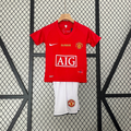 Ensemble enfant Manchester United Le 12 -ème Maillot, maillot rouge avec logo du club et détails en blanc, pour jeunes supporters.